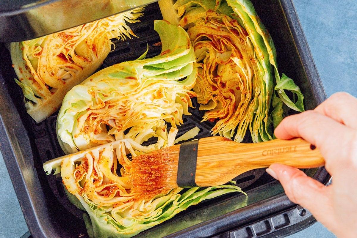 Marinade wird auf Kohl in der Heißluftfritteuse gepinselt.