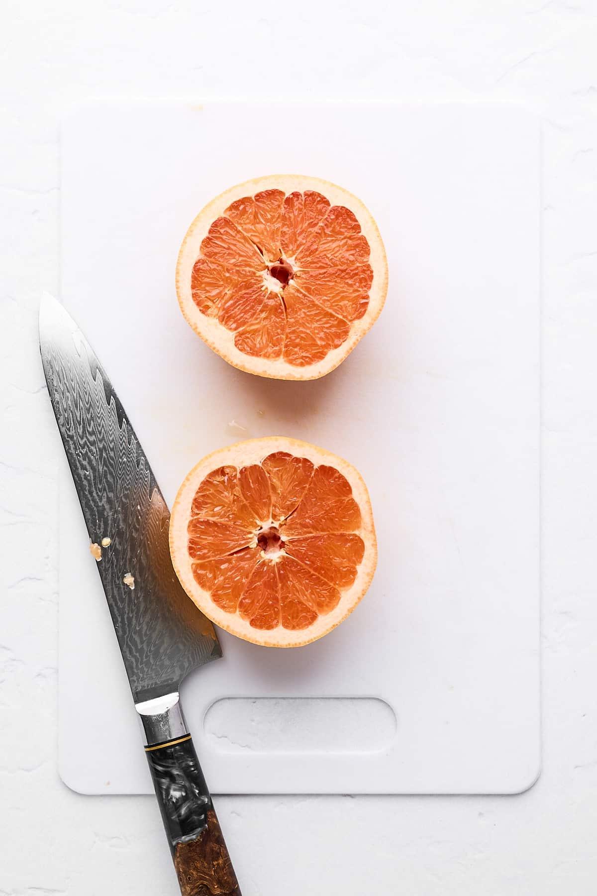 Wie man eine Grapefruit schneidet 3 Eine halbierte Grapefruit auf einem Schneidebrett.