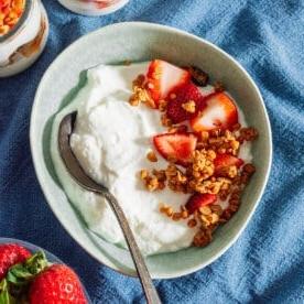 Griechischer Joghurt in einer Schüssel mit Müsli und Obst.