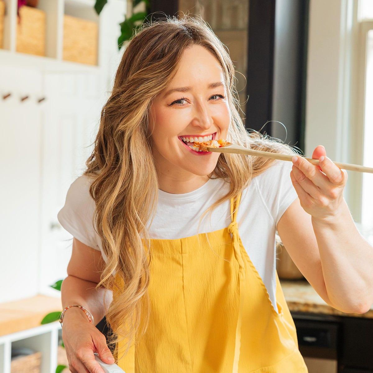 Sarah Bond, the vegetarian food blogger behind Live Eat Learn, poses in front of her stove.