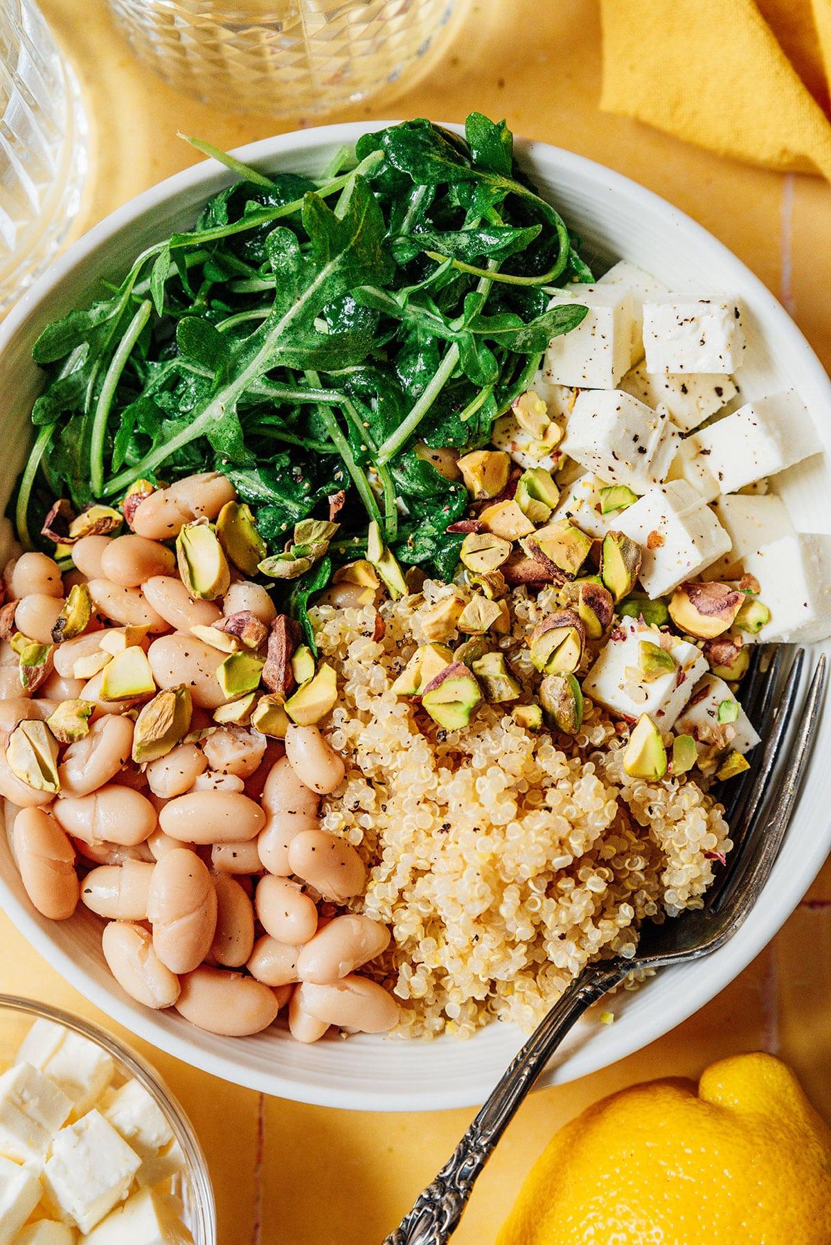 Vegetarische 31-Tage-Herausforderung 7 Zitronen-Rucola-Bowl auf gelben Fliesen.