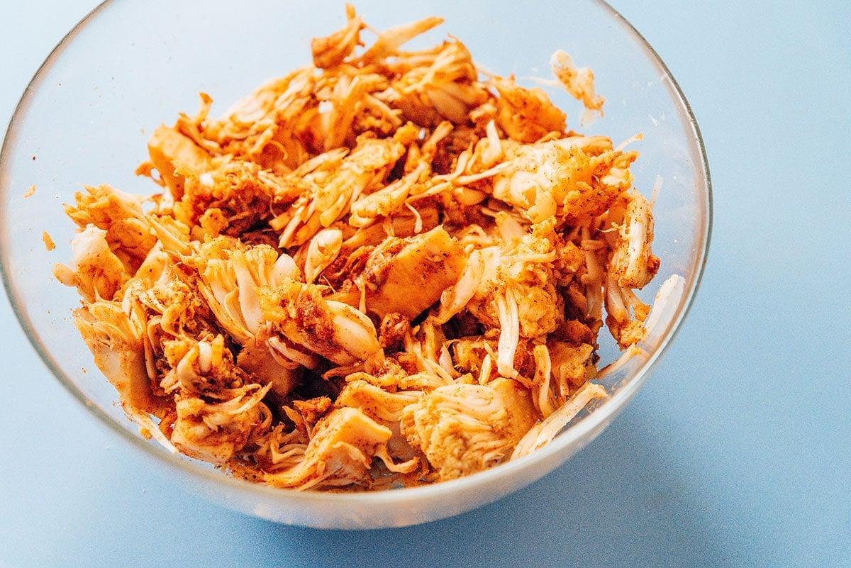 BBQ Jackfrucht Pulled Pork (Fertig in 30 Minuten) 8 Jackfrucht, die mit allen Gewürzen in der Schüssel vermischt und nun braun gefärbt ist.