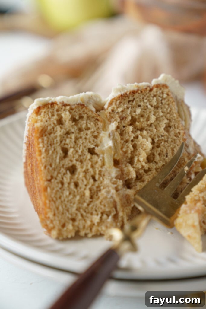 Close-up of a mini apple cake showing the apple filling and frosting