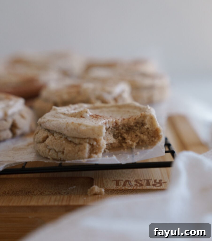 Close-up of a soft Chai Sugar Cookie with creamy frosting, showing its inviting texture.