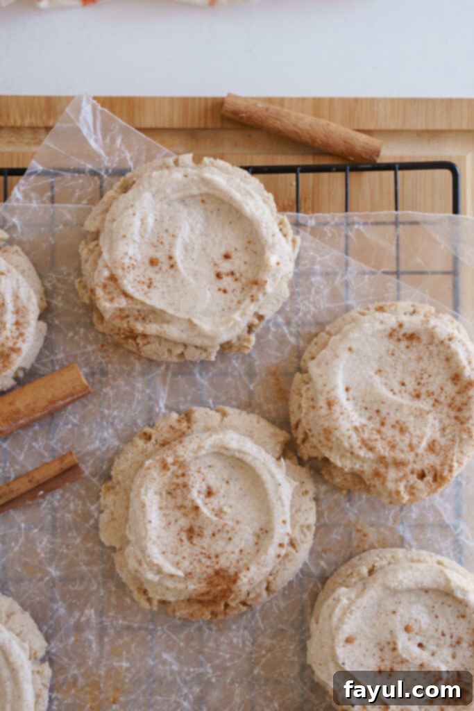 A top-down view of several Chai Sugar Cookies on a white plate, showing the beautifully frosted tops.