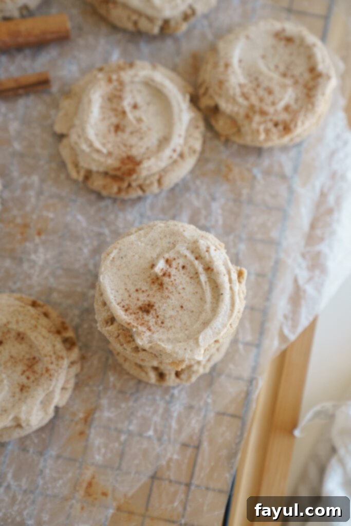 A perfectly baked Chai Sugar Cookie with smooth cream cheese frosting, ready for a bite.