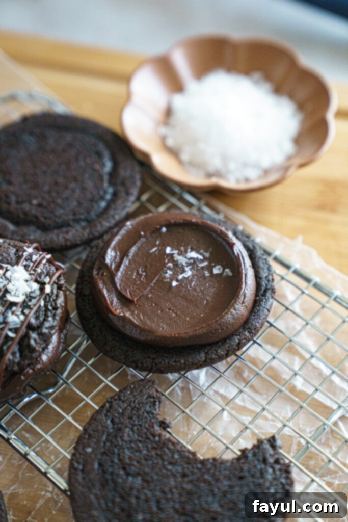 Double chocolate cookie sandwhich being assembled