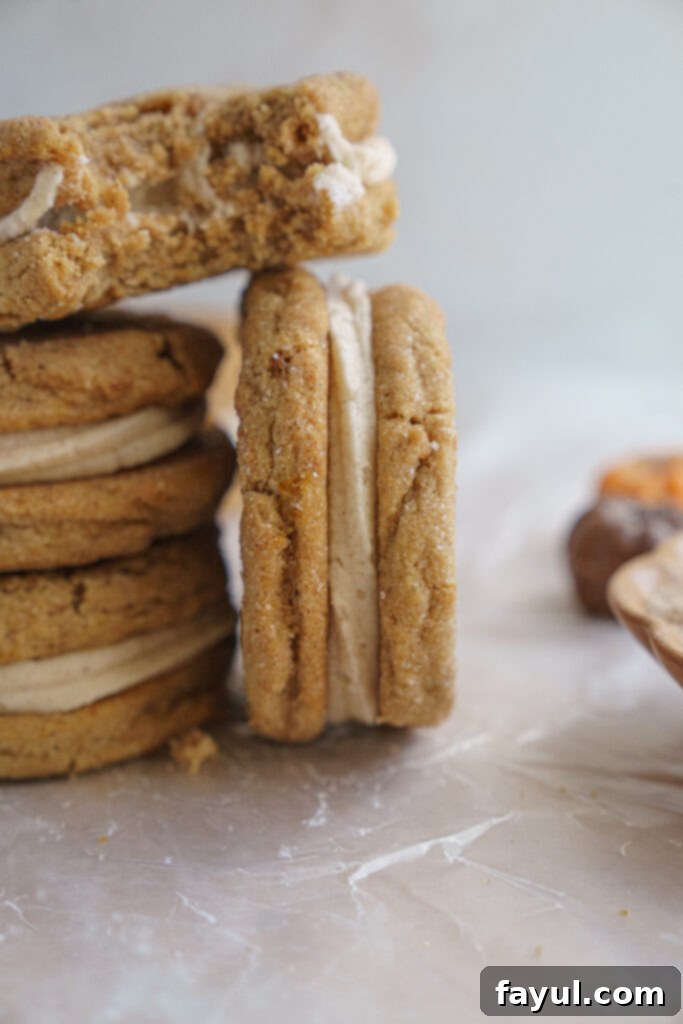 Close-up of a Pumpkin Sandwich Cookie showing the soft cookie and creamy frosting