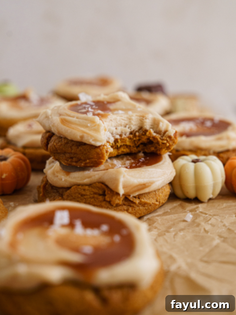 Delicious Pumpkin Caramel Cookies topped with creamy frosting and caramel swirl, perfect for fall