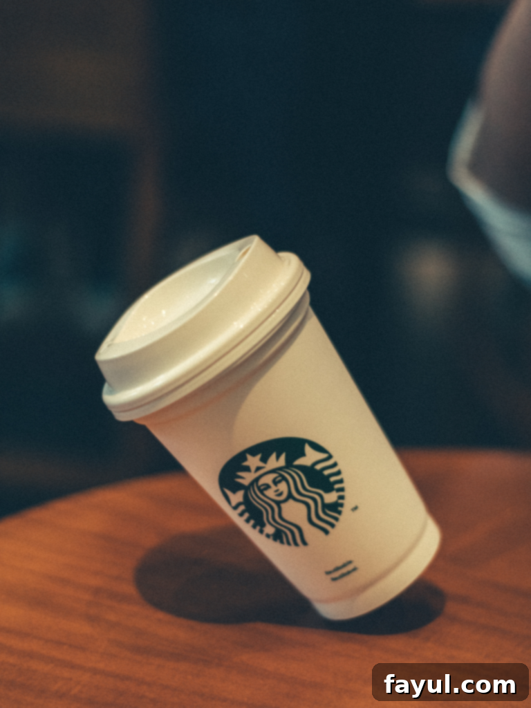A steaming cup of Emperor’s Clouds & Mist Green Tea in a clean Starbucks mug.