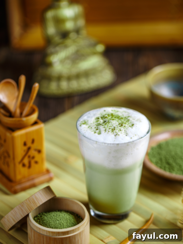 A creamy green tea latte in a Starbucks cup, showing its distinct vibrant color.