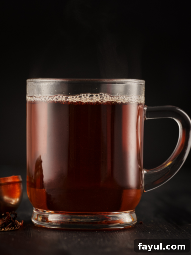A steaming cup of Hot Earl Grey Tea in a classic Starbucks mug.