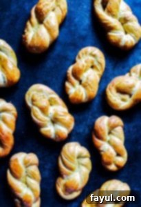 Homemade soft pretzels on a blue counter with various cheese sauces.