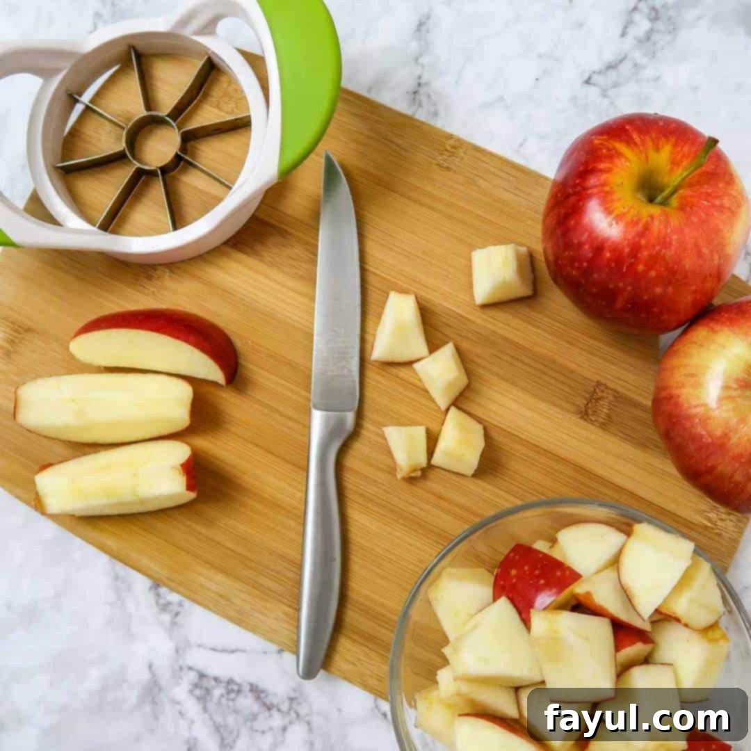 Overhead view of first process shot- slicing apples into small cubes.