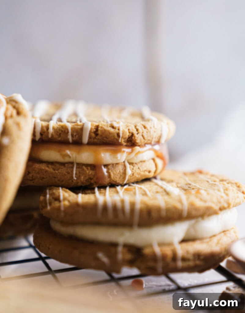 A stack of Gingerbread Caramel Cookie Sandwiches with visible caramel filling.