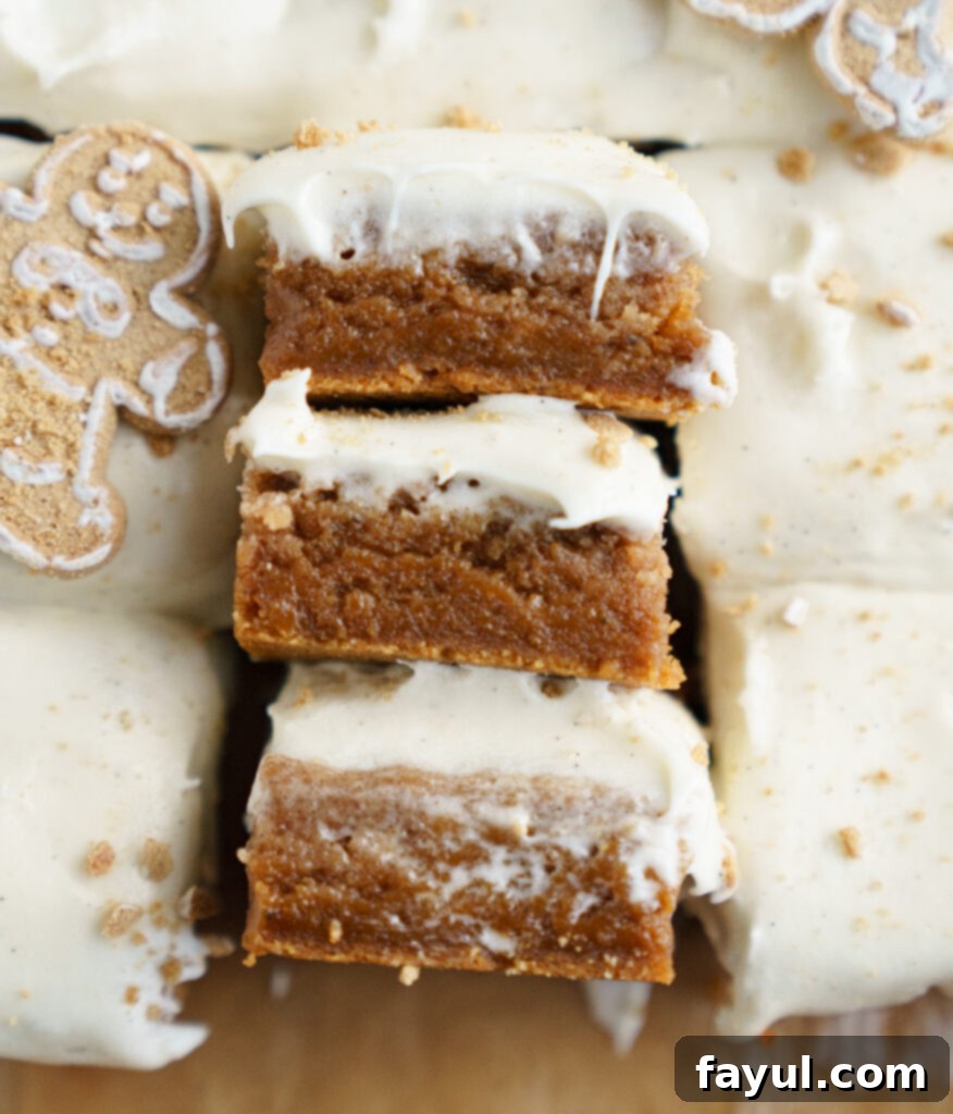 Close-up of a gingerbread cinnamon roll blondie bar with visible frosting