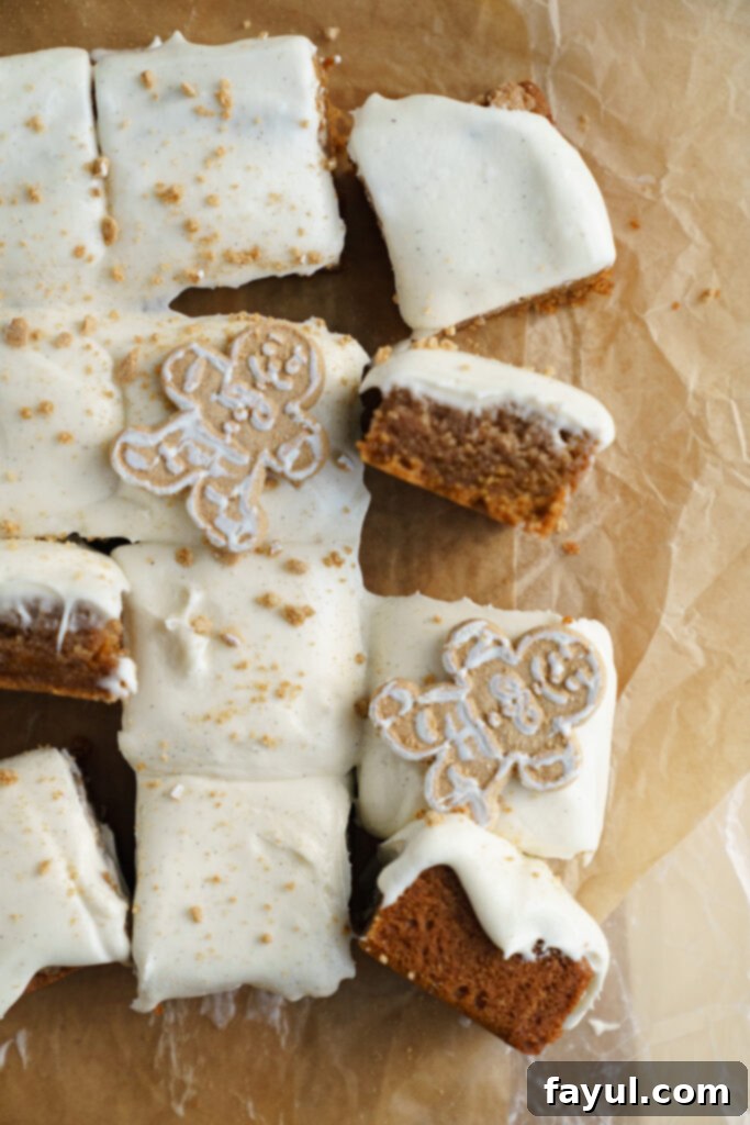 Stack of gingerbread cinnamon roll blondies with a bite taken out