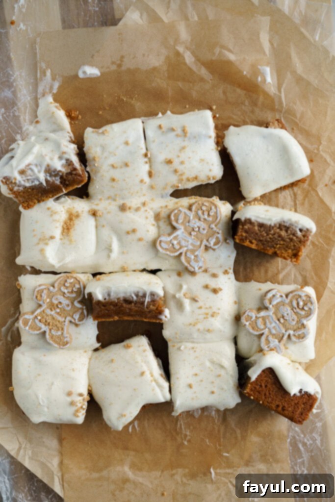 A single gingerbread cinnamon roll blondie, showing the swirl and frosting