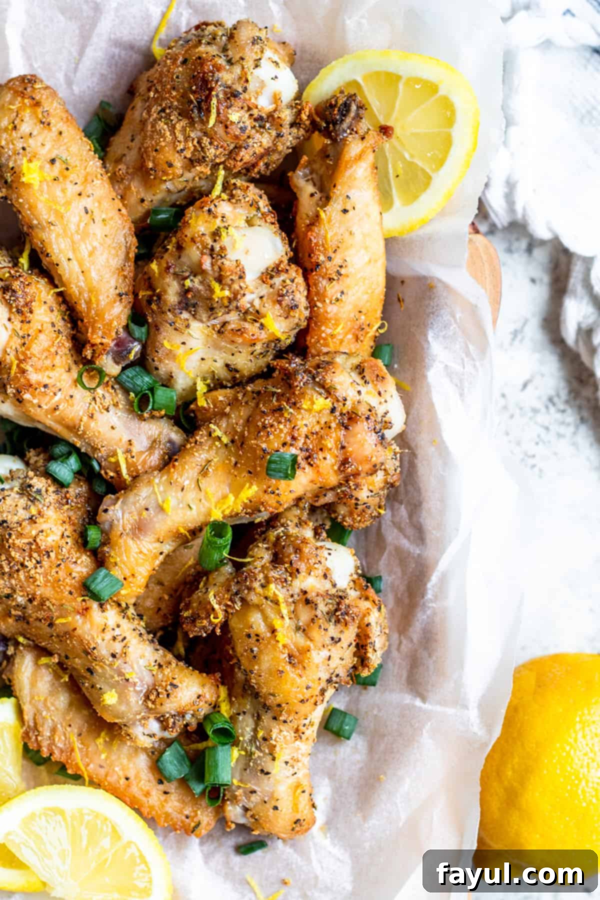 Crispy Air Fryer Lemon Pepper Chicken Wings 4 Overhead shot of chicken wings with lemon slices.