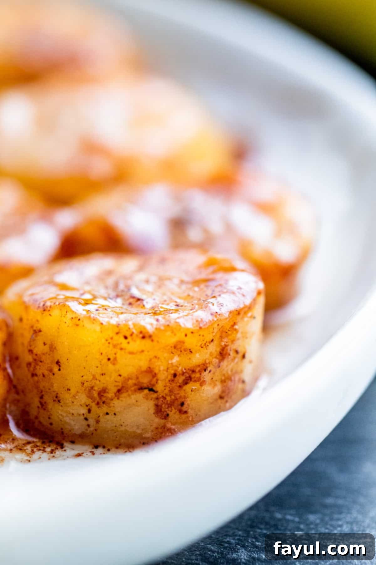 Close up shot of fried banana on white plate.