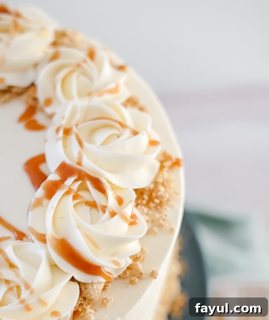 Close-up of a slice of White Chocolate Caramel Pretzel Cake with visible pretzel filling