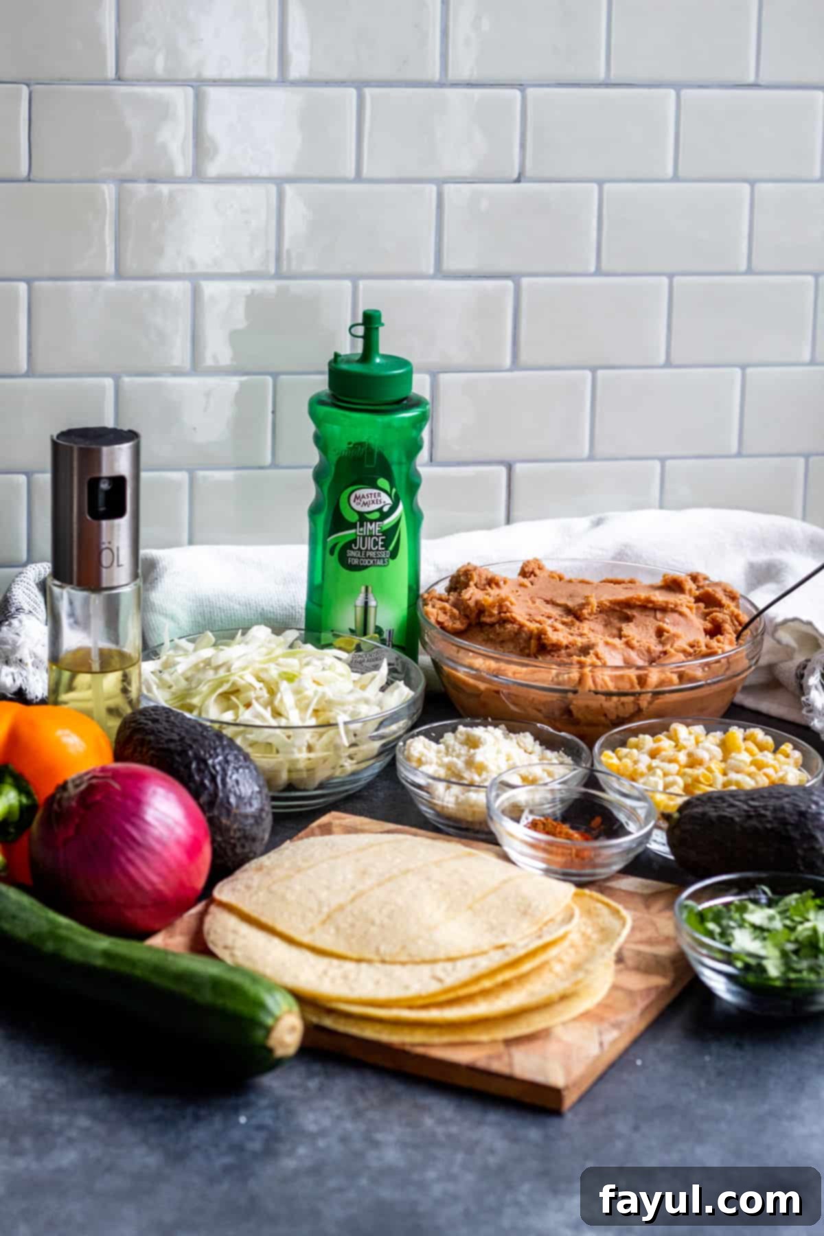 Crispy Vegetarian Tostadas with Bright Cilantro Lime Slaw 3 Tostada ingredients laid out on blue counter.