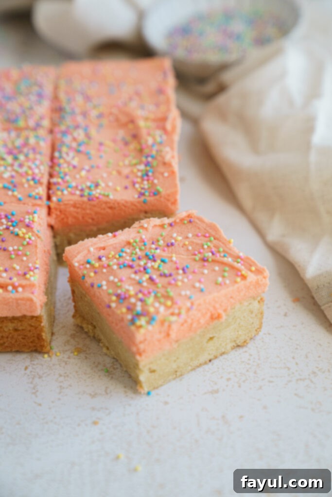 Delicious brown butter sugar cookie bars with cream cheese frosting on a white platter