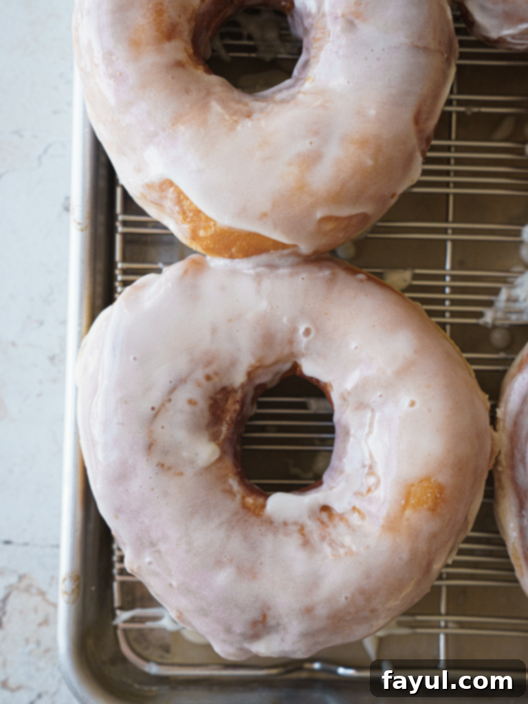 Golden brown brioche donut with a thick vanilla glaze