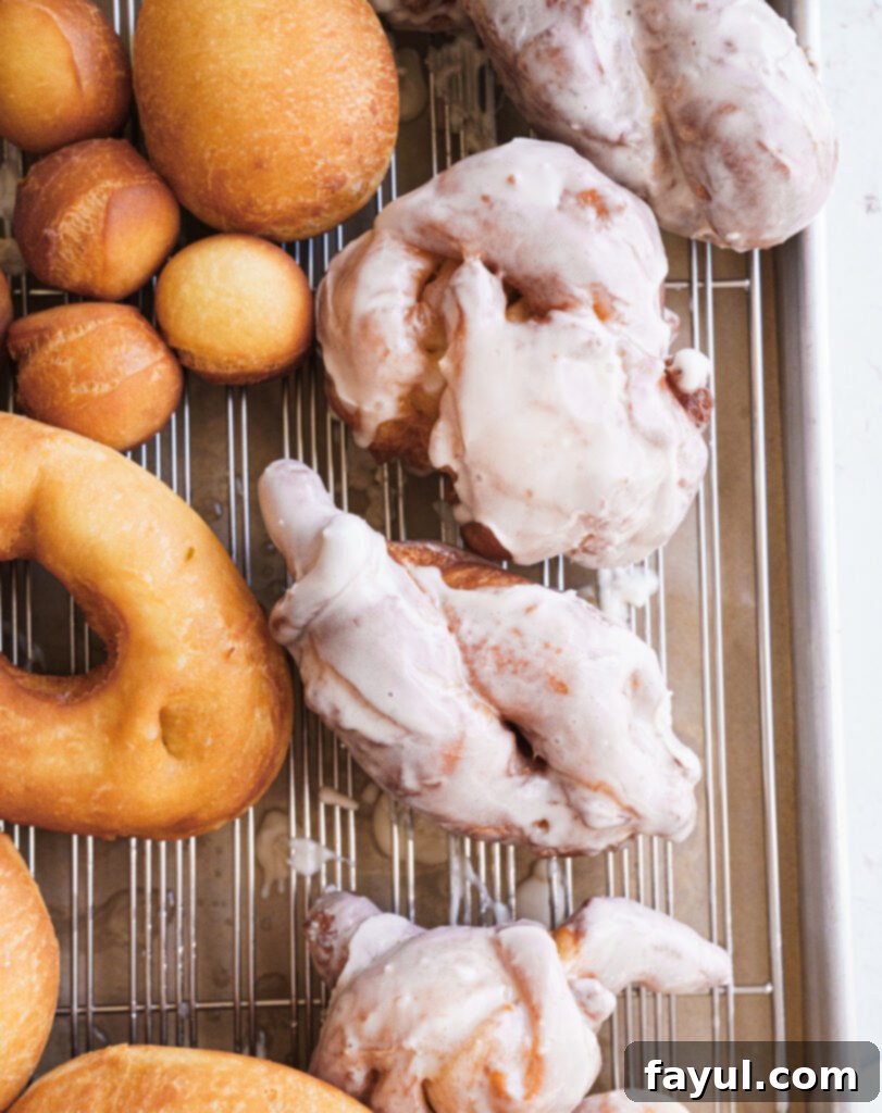 Close-up of three golden brioche donuts stacked, showing their fluffy texture