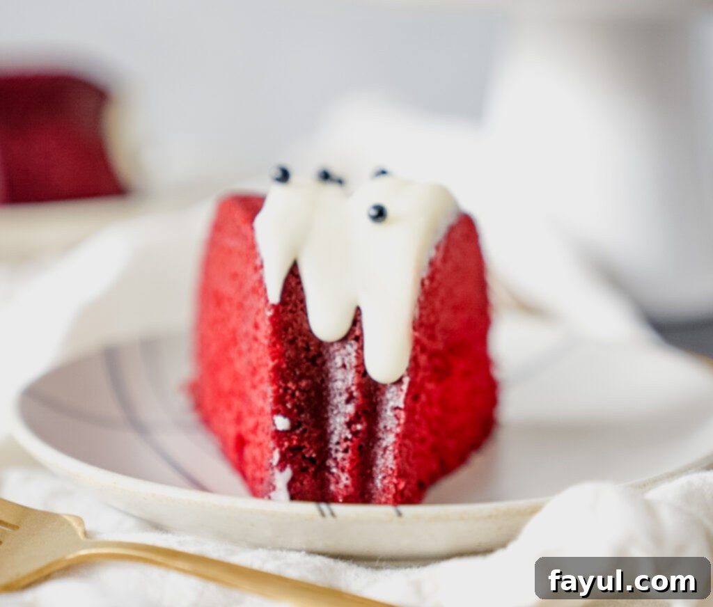 Close-up of the moist interior of a Red Velvet Bundt Cake, showcasing its vibrant red color and tender crumb.