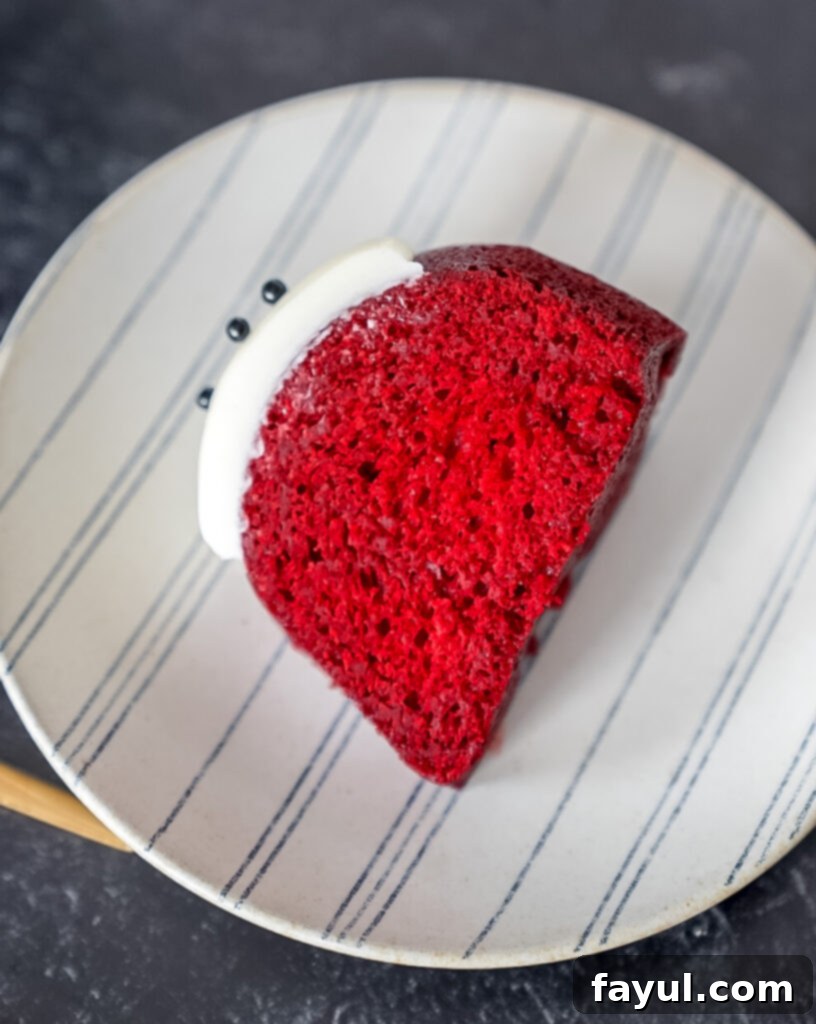 A close-up of a bowl containing red velvet emulsion, emphasizing its vibrant color.