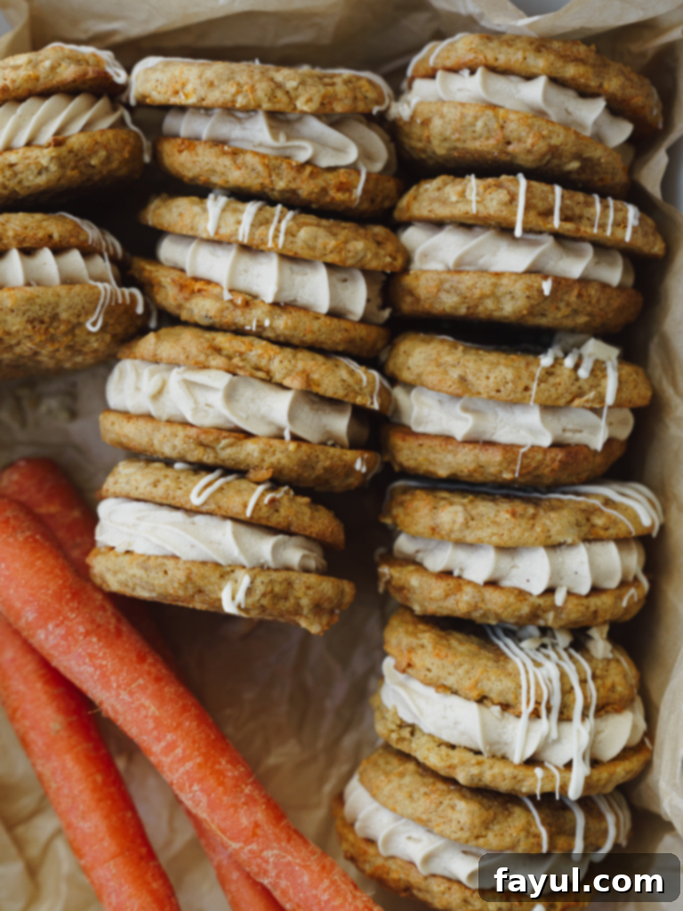 Carrot Cake Cookie Sandwich - two perfectly frosted carrot cake cookies sandwiched together on a white background