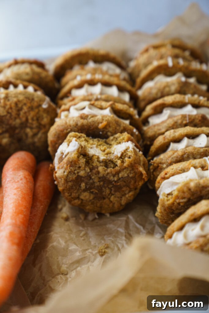 Pile of soft, spiced carrot cake cookies cooling on a wire rack.