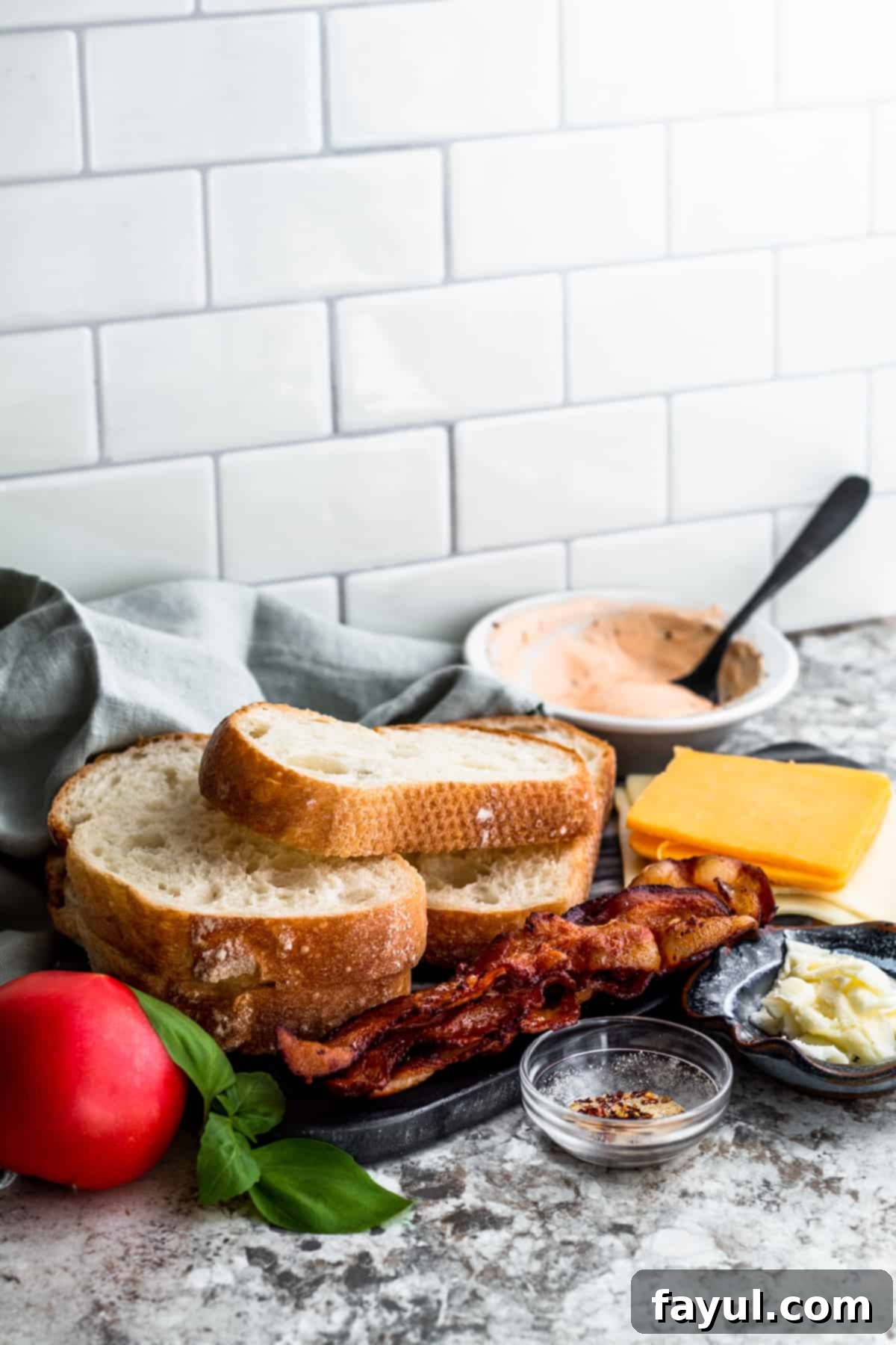 Grilled cheese ingredients beautifully laid out on a clean white counter, ready for assembly.