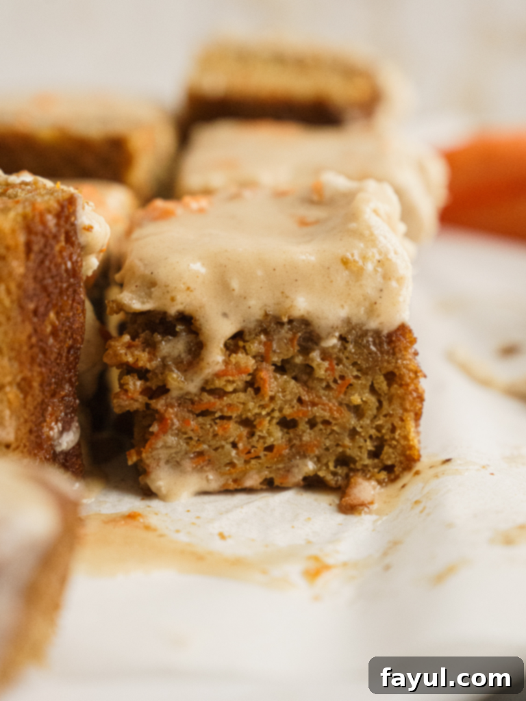 Slice of Caramel Carrot Cake with Chai Spiced Frosting, showing caramel swirl