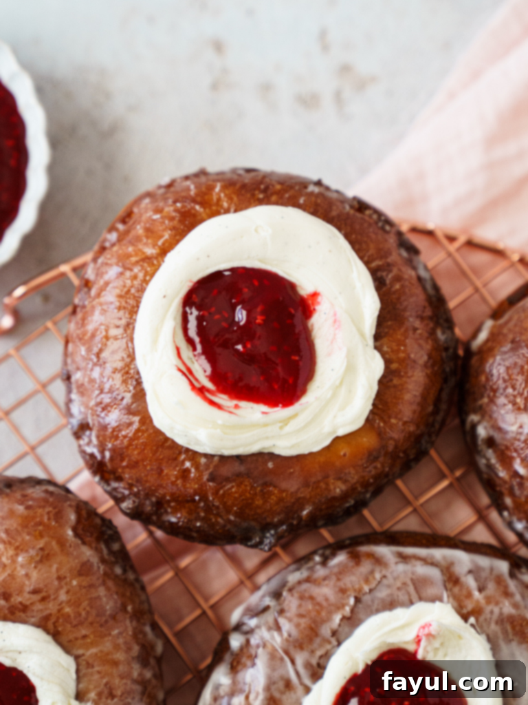 Homemade Brioche Jelly Donuts with raspberry jam and cream cheese frosting