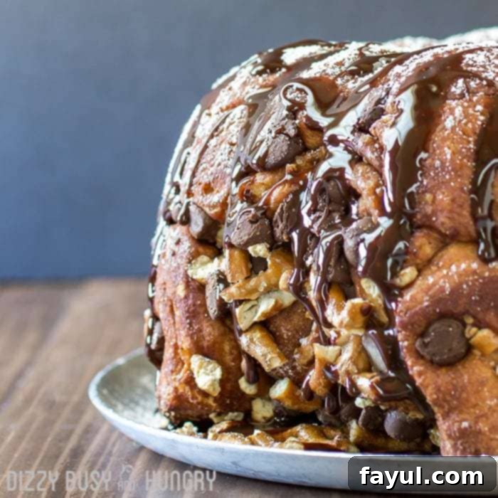 Close up shot of the whole chocolate pretzel monkey bread on a grey plate. 
