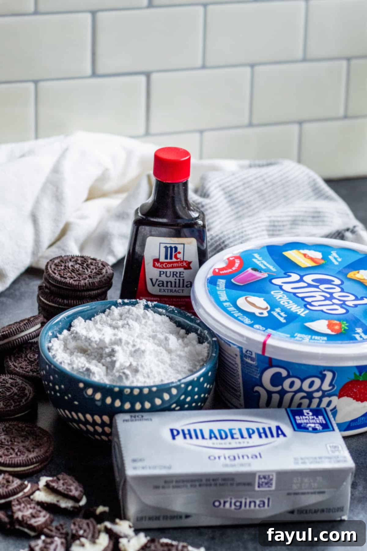 Effortless Oreo Dip Delight 3 Ingredients for the quick and easy Oreo dessert dip arranged neatly in bowls and packaging on a kitchen counter.