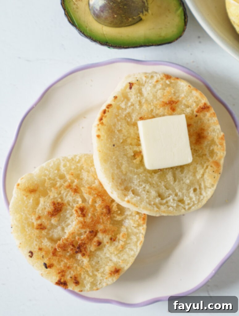 Stack of homemade English muffins with a fork, ready to be split