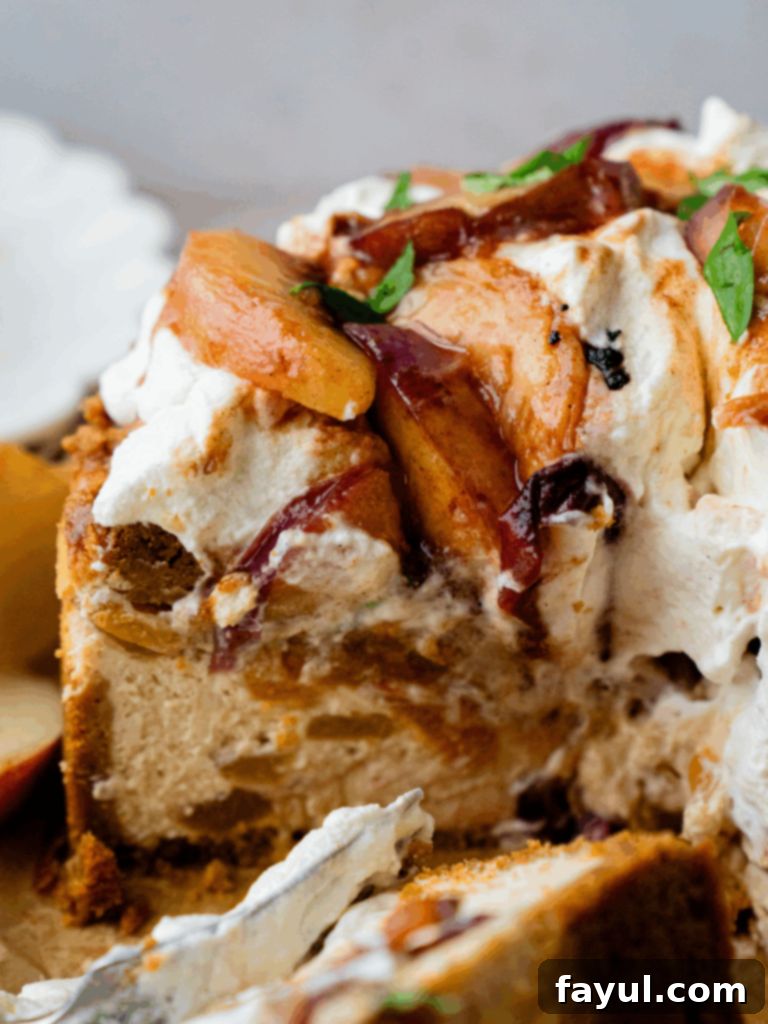 A slice of Peach Cobbler Cheesecake with a creamy filling, peach topping, and streusel