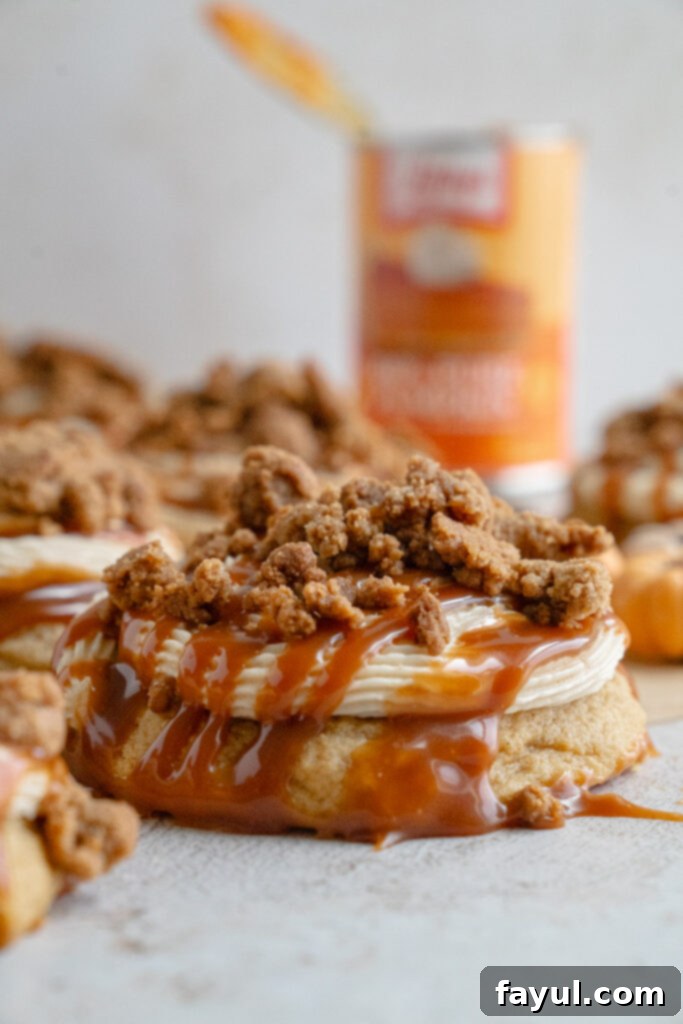 Stack of soft pumpkin caramel cookies showing fluffy texture with frosting and caramel topping.