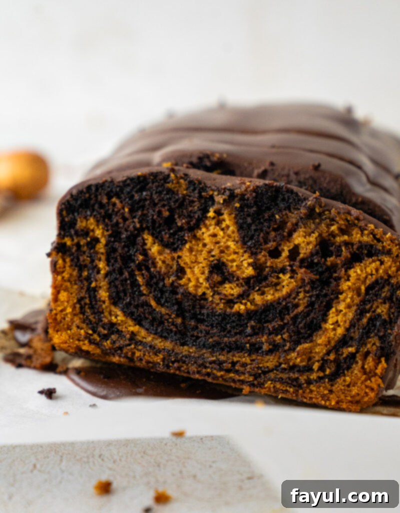 Two beautiful slices of pumpkin chocolate swirl bread on a cutting board, ready to eat