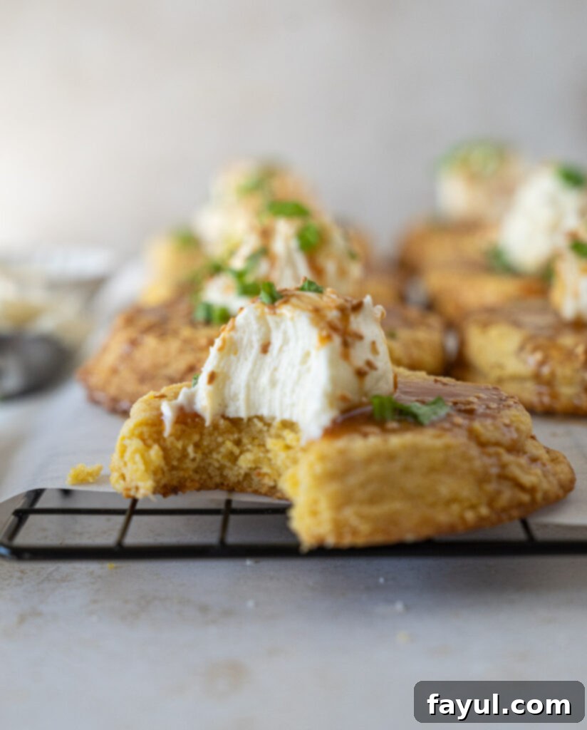 Close-up of Savory Cornbread Cookies with Sesame Buttercream and Soy Caramel Drizzle, garnished with green onions.