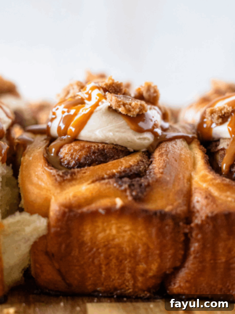 Gooey Dulce de Leche Cinnamon Rolls topped with frosting and streusel