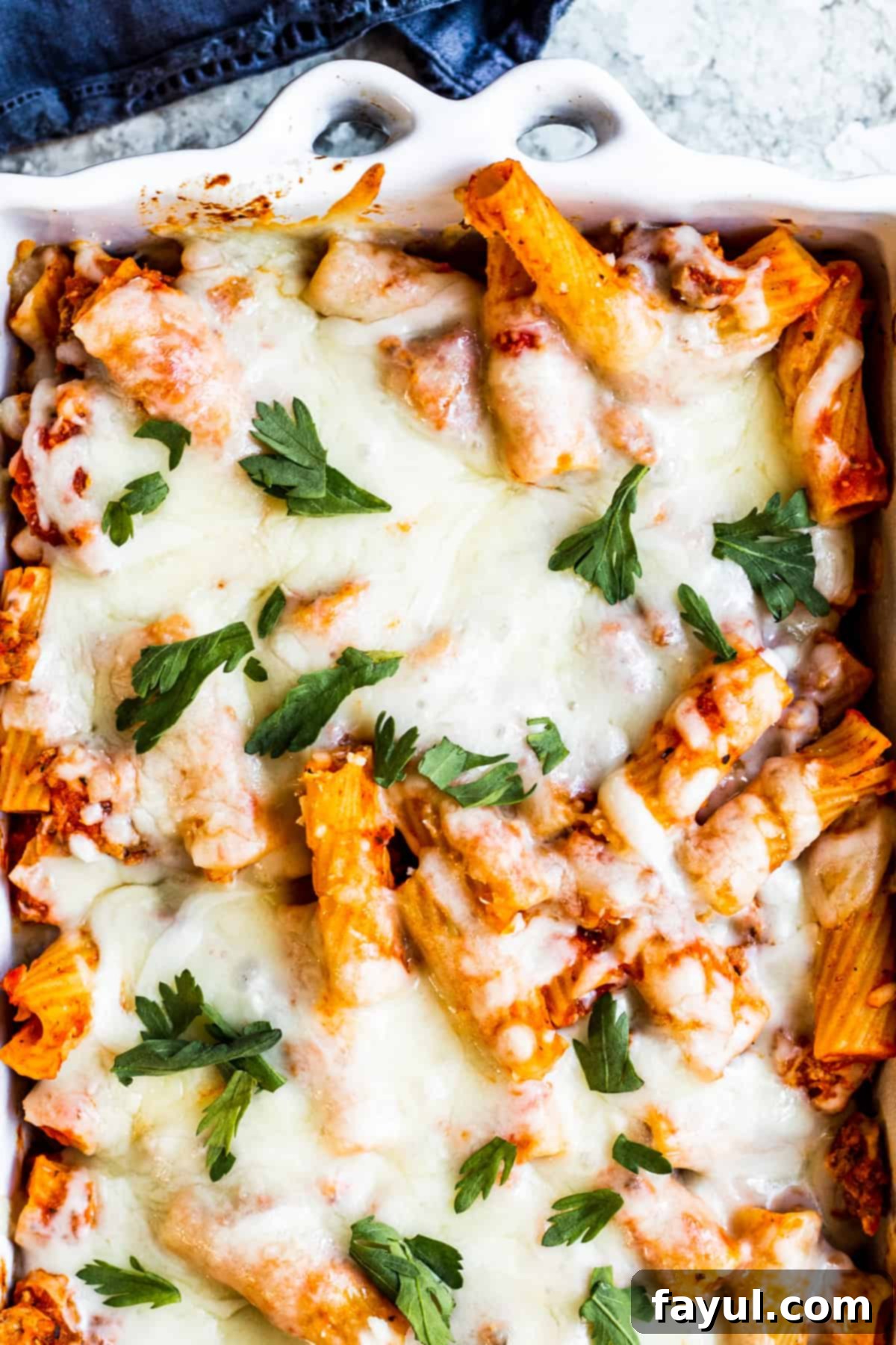 Overhead shot of pasta in baking dish on white counter.