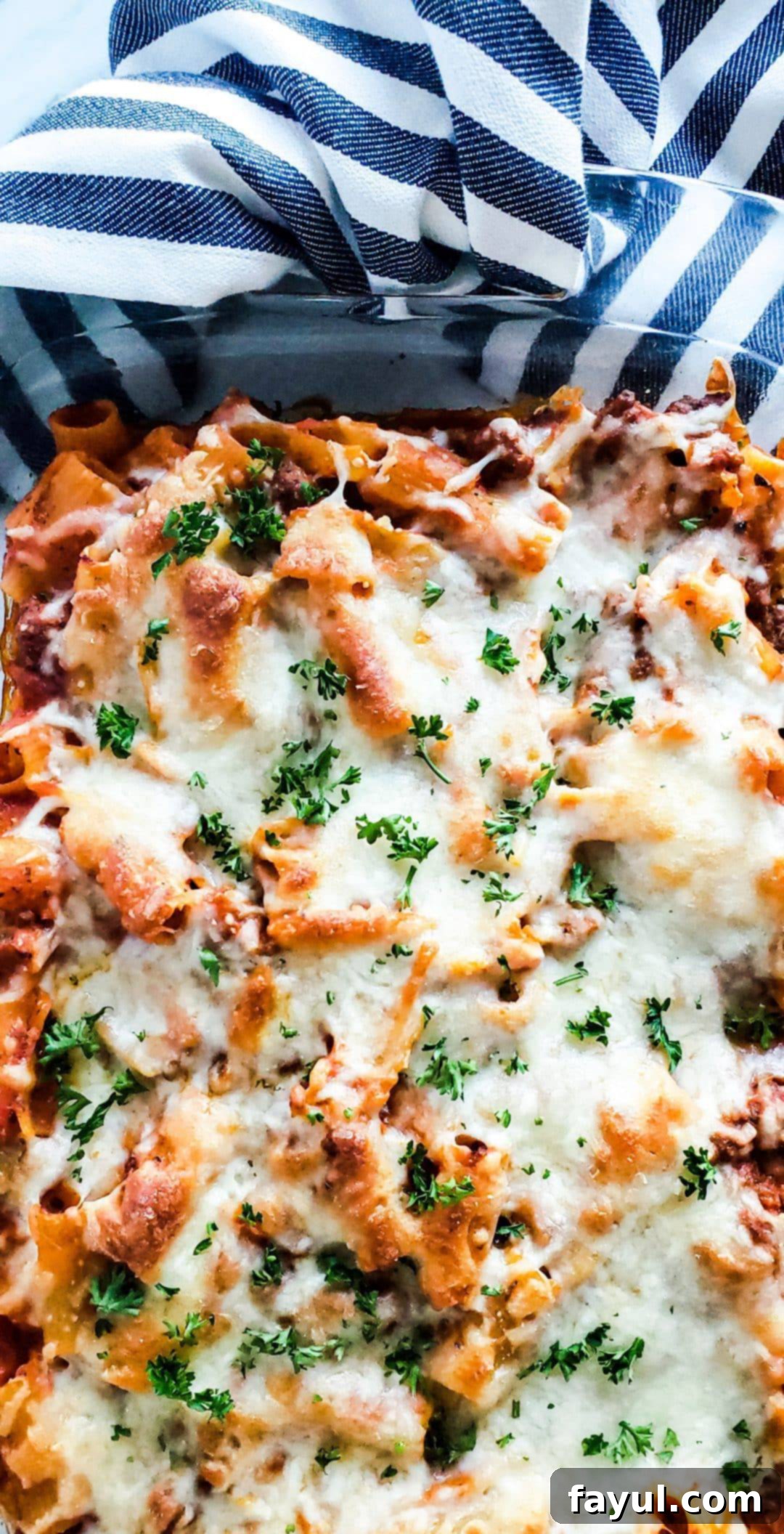 Overhead shot of baked mostaccioli in a glass baking dish.