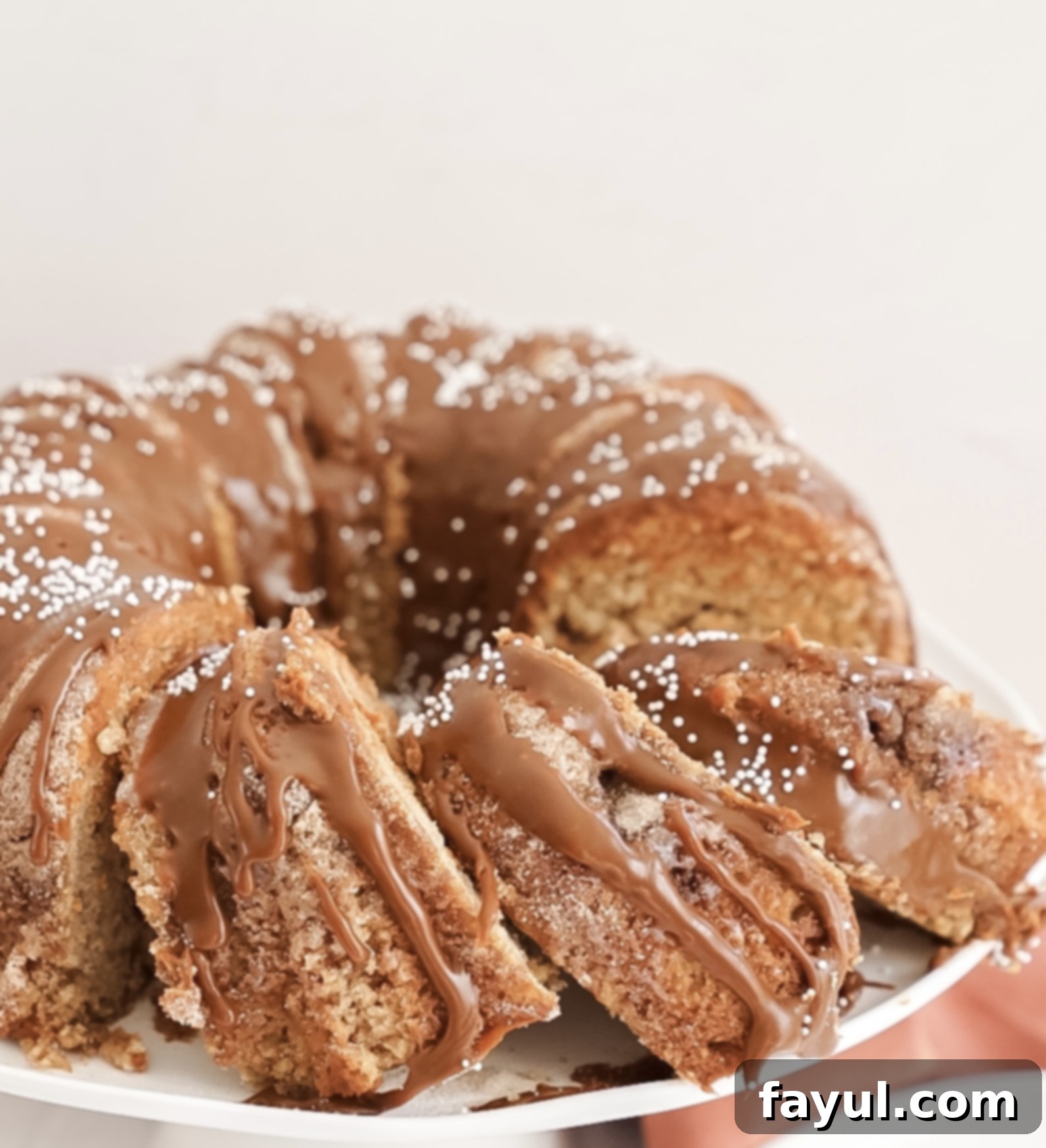 Perfectly baked churro bundt cake, golden brown and coated with cinnamon sugar, cooling on a rack.