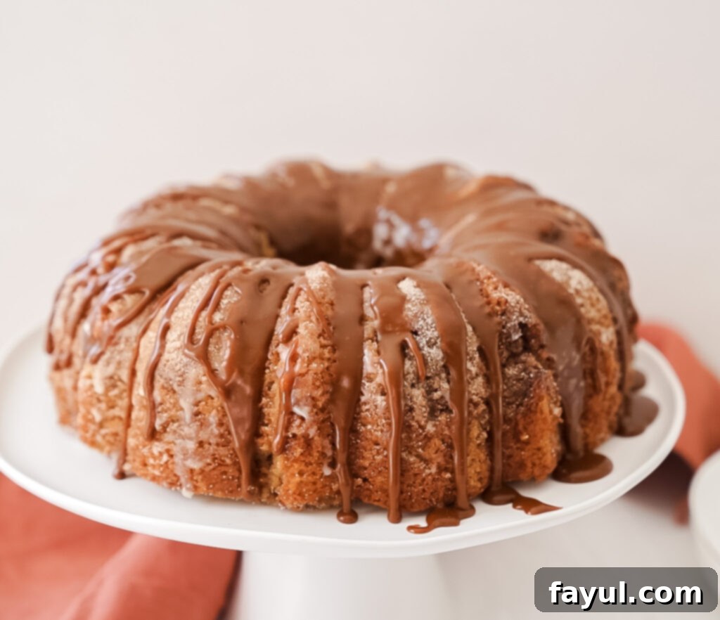Churro bundt cake being brushed with melted butter, preparing it for the final cinnamon sugar coating.