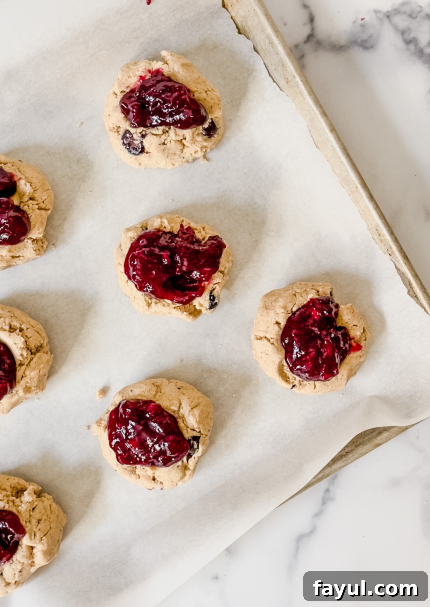 Freshly baked browned butter blueberry cookies cooling on a wire rack