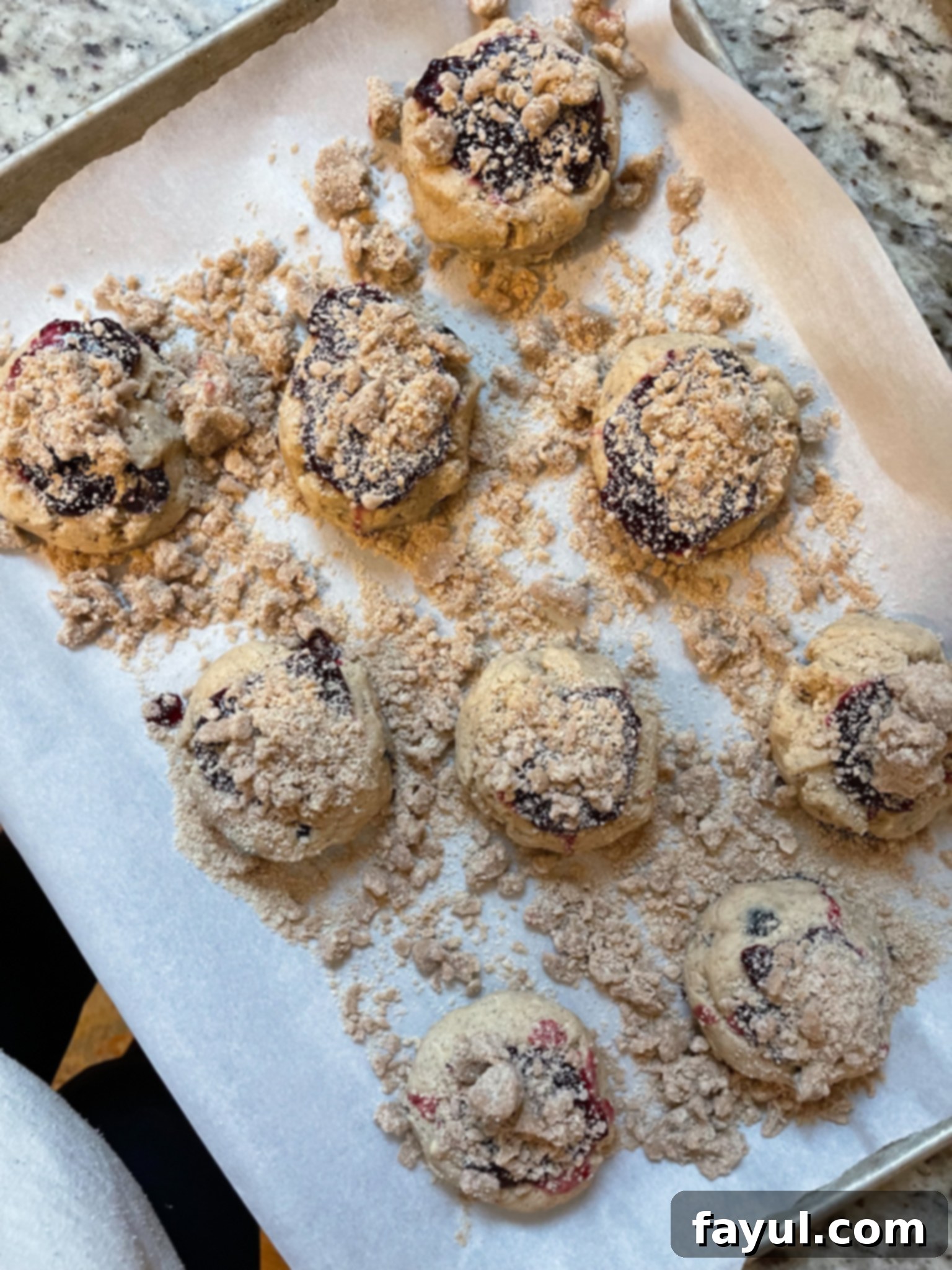 Closeup of a browned butter blueberry cookie, highlighting the texture and filling